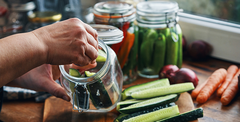 Sliced cucumbers in a glass jar